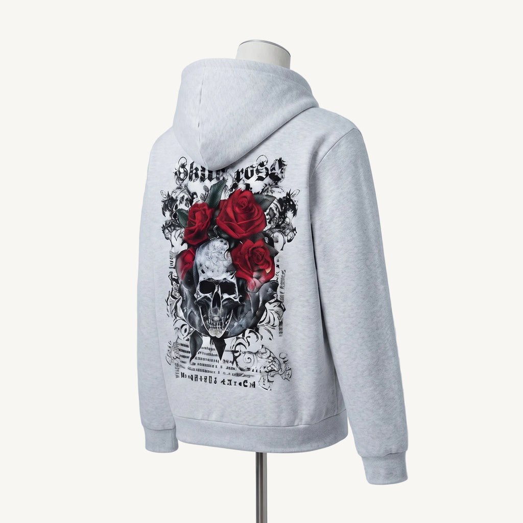 A light gray heather hoodie displayed on a mannequin, showing the back graphic. The design features a black and white skull surrounded by three red roses with gothic-style text reading 'Shiet roset' and 'Merry go'.