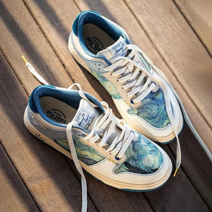 Pair of sneakers with artistic design on a wooden surface