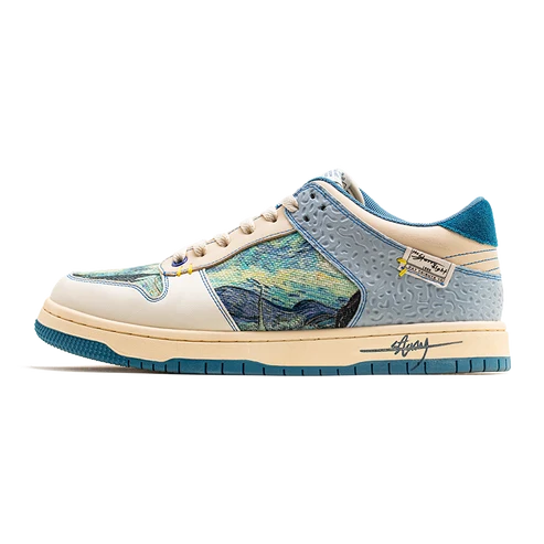 A low-top sneaker featuring a light blue and teal textured leather base with a central panel depicting a stylized landscape in blue, yellow, and green tones. The shoe has cream-colored overlays, beige laces, and a matching cream and teal midsole with a visible 'Stussy' script logo on the side.