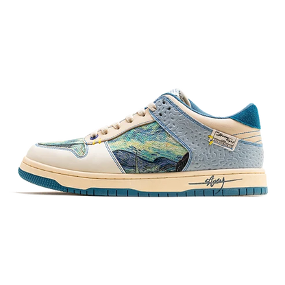 A low-top sneaker featuring a light blue and teal textured leather base with a central panel depicting a stylized landscape in blue, yellow, and green tones. The shoe has cream-colored overlays, beige laces, and a matching cream and teal midsole with a visible 'Stussy' script logo on the side.